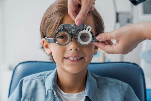 boy having eye test with optometrist