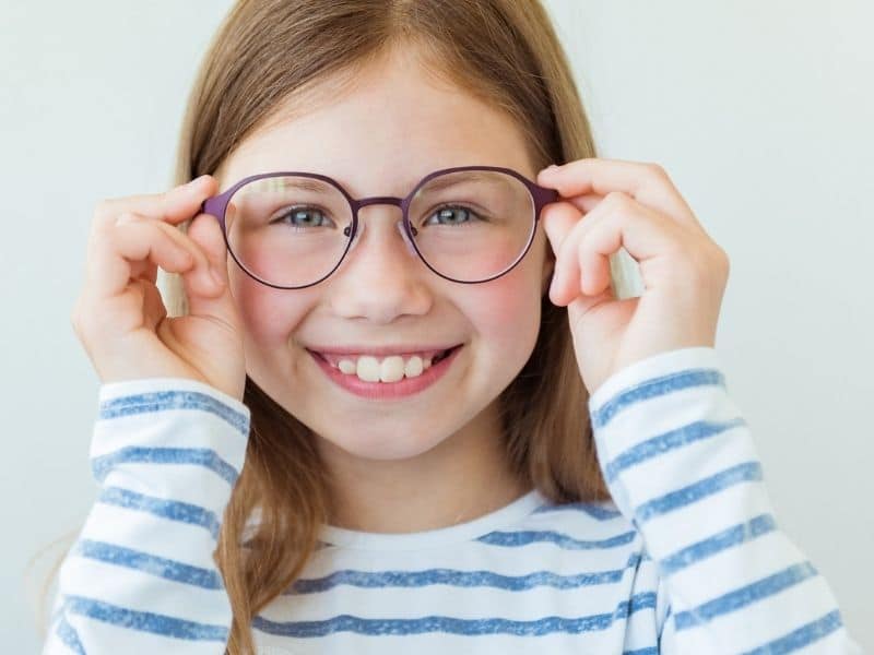 girl holding glasses with clear vision