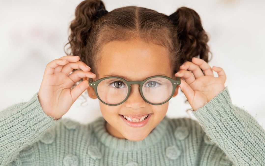 a little girl wearing myopia glasses with vision eye care.