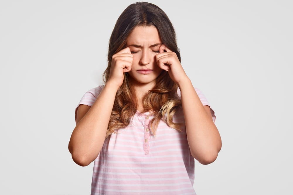 woman rubbing eyes suffering from dry eye symptoms