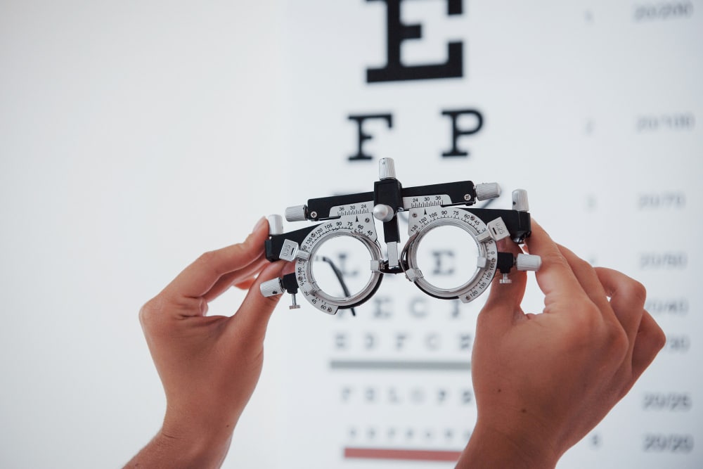 optometrist woman holding phoropter